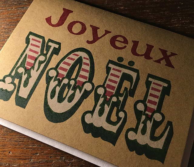 Hand printed greeting card that reads "Joyeux Noel"
